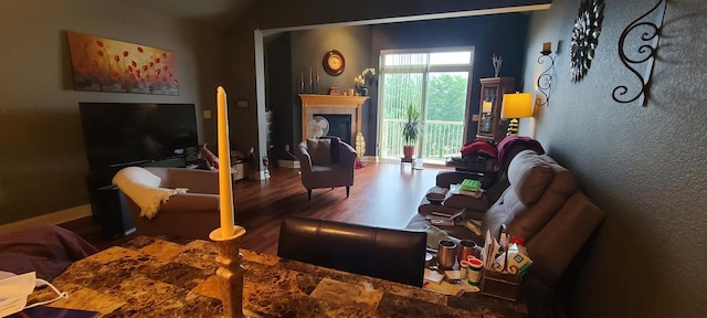 living room with wood-type flooring and a fireplace