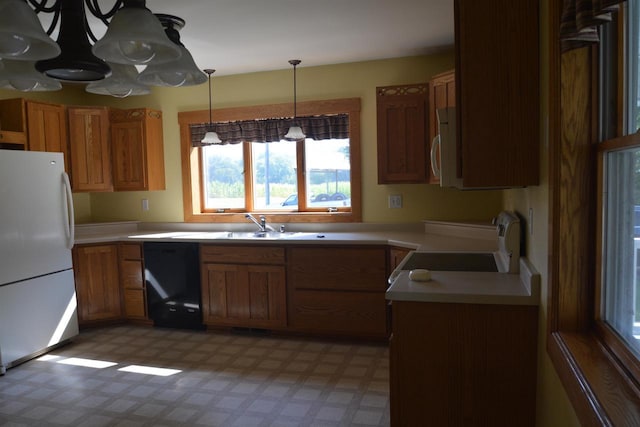 kitchen featuring stainless steel microwave, light floors, black dishwasher, freestanding refrigerator, and stove