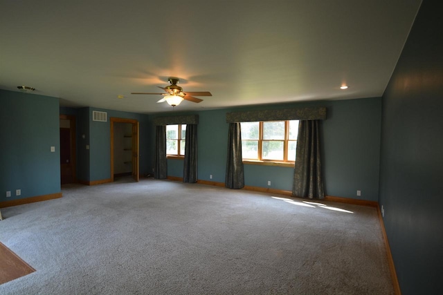 unfurnished room featuring visible vents, carpet, and baseboards