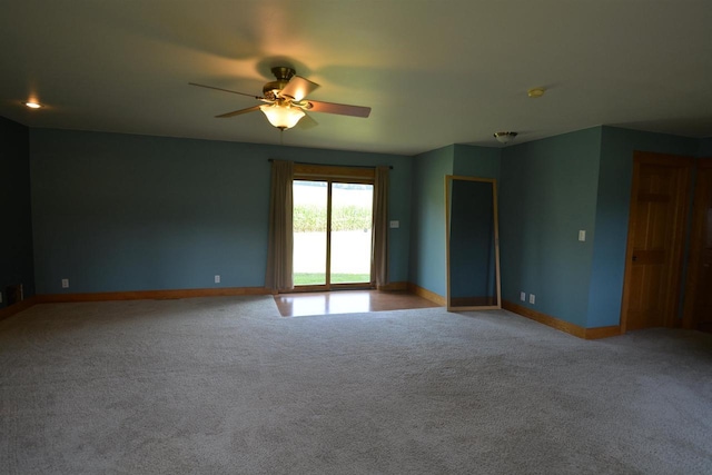 unfurnished room featuring baseboards, light colored carpet, and a ceiling fan