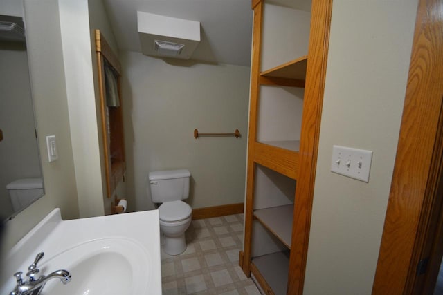 bathroom featuring vanity, visible vents, baseboards, tile patterned floors, and toilet