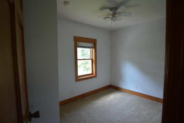 spare room with baseboards, carpet floors, and a ceiling fan