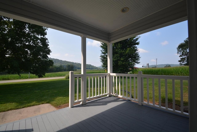 wooden terrace featuring a yard