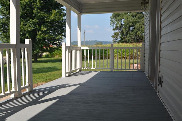 wooden deck featuring a yard