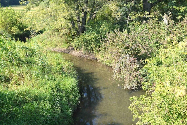 birds eye view of property featuring a view of trees