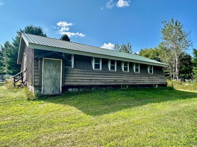 back of property featuring a lawn