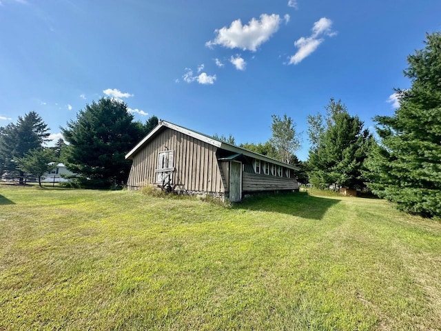 view of side of home with a lawn