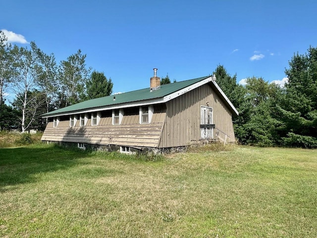 view of side of home featuring a yard