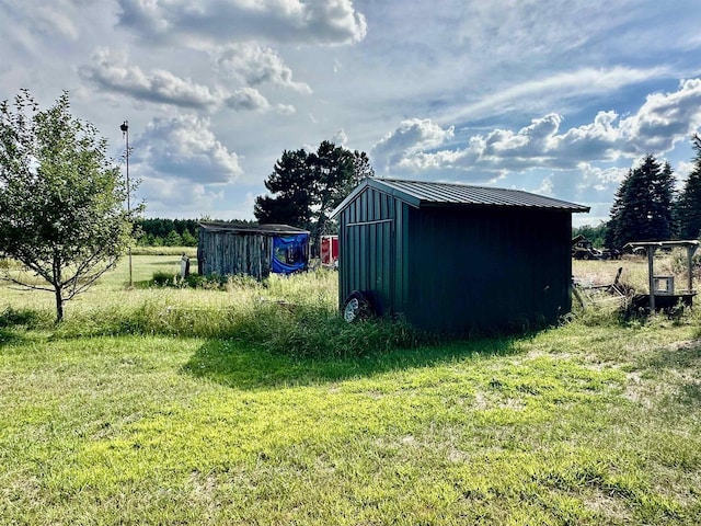 view of outdoor structure featuring a lawn