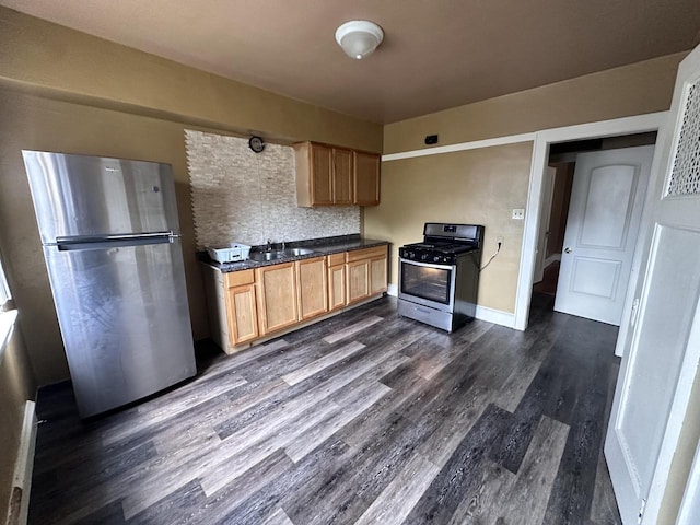 kitchen featuring decorative backsplash, a baseboard radiator, sink, stainless steel appliances, and dark hardwood / wood-style flooring