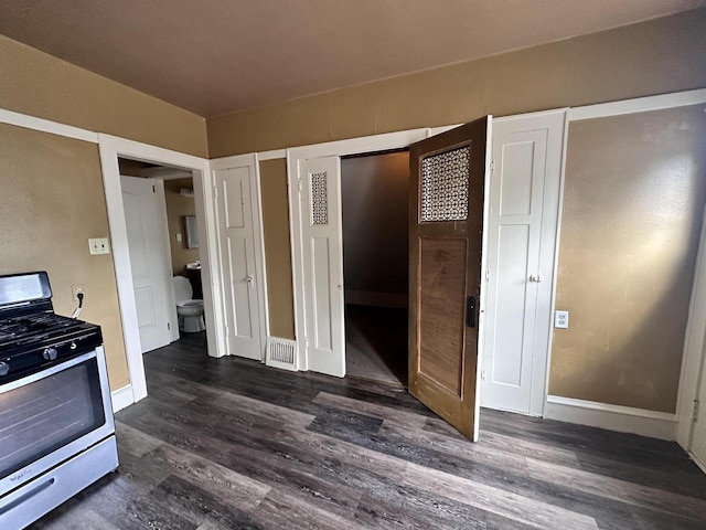 kitchen with dark wood-type flooring and stainless steel gas stove