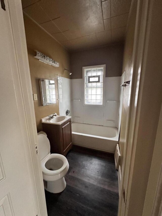 full bathroom featuring vanity, toilet, shower / tub combination, and hardwood / wood-style flooring