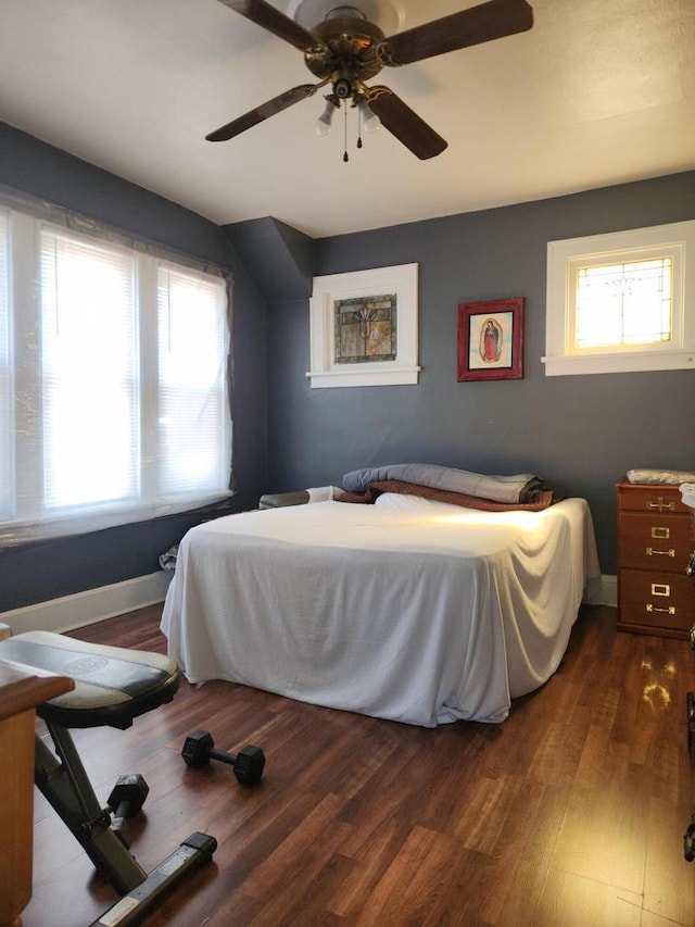 bedroom with dark wood-type flooring and ceiling fan