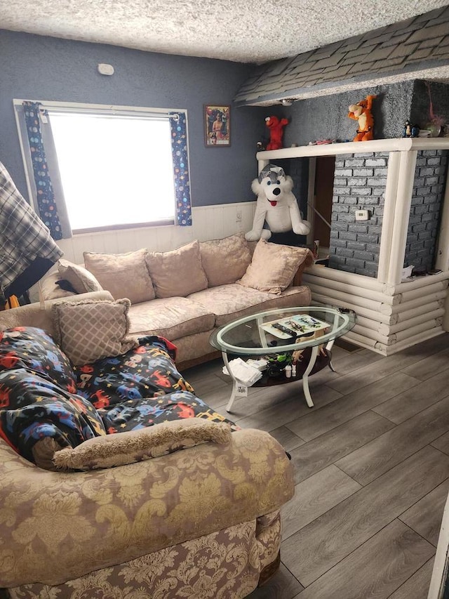 living room with hardwood / wood-style floors and a textured ceiling