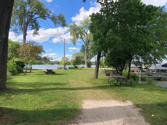 view of property's community featuring a water view and a yard