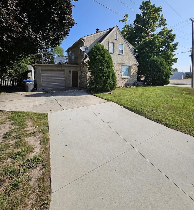 view of front of home featuring a garage and a front lawn