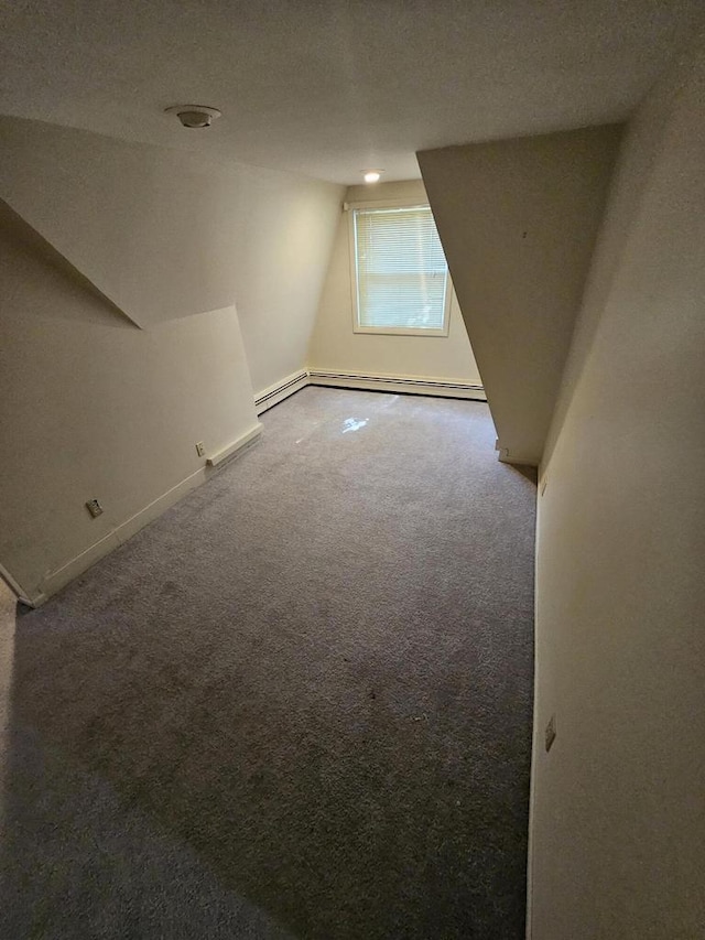 additional living space featuring carpet, lofted ceiling, and a baseboard heating unit