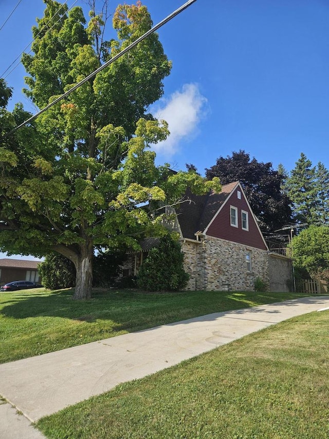 view of home's exterior with a yard