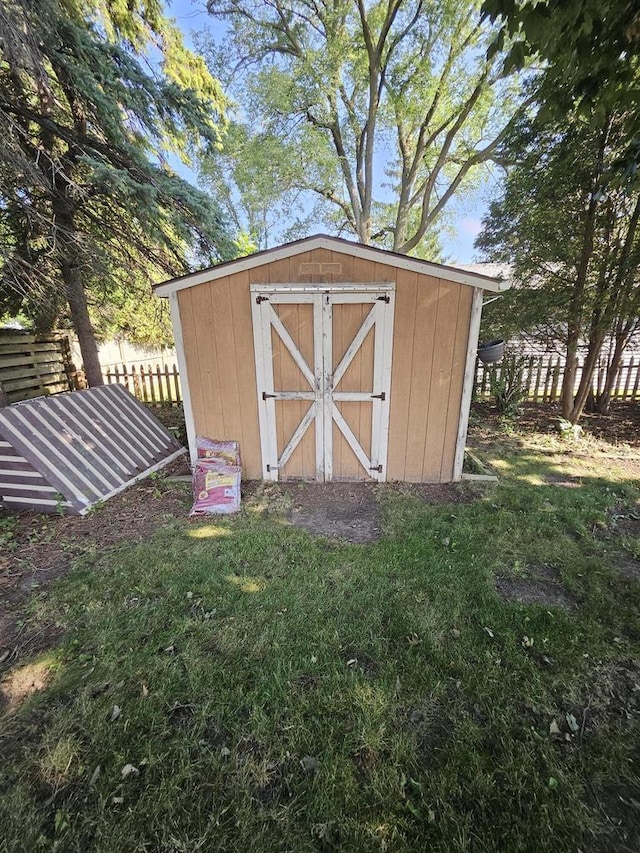 view of outdoor structure featuring a lawn