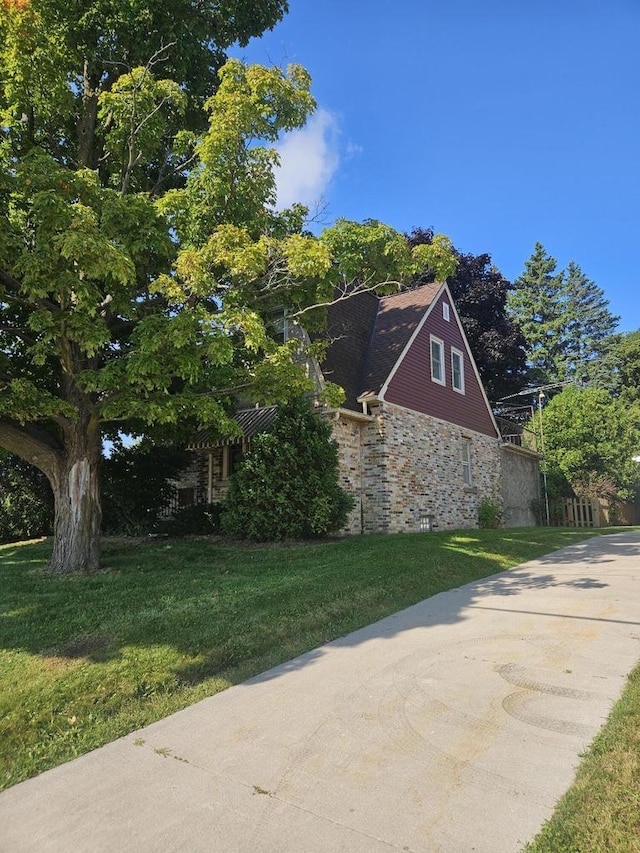 view of side of property with a lawn