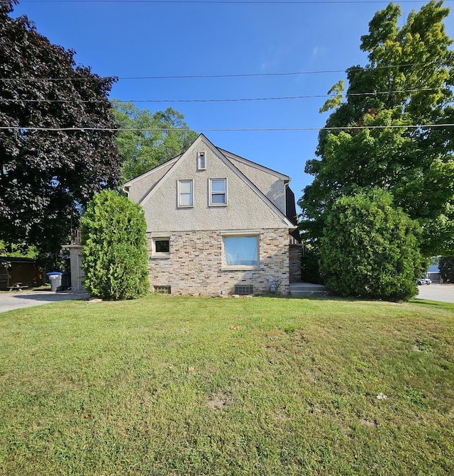 view of side of home with a lawn