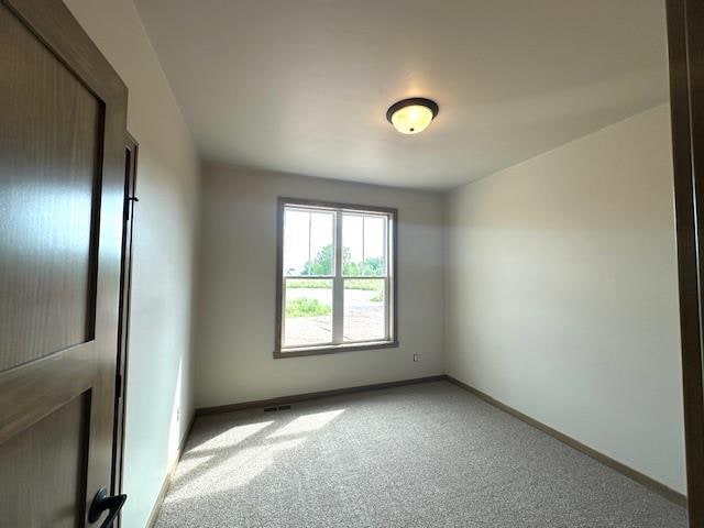 empty room featuring light carpet