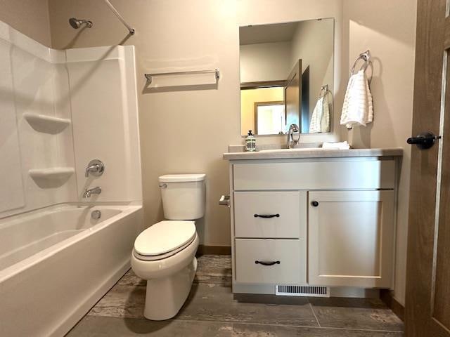 full bathroom with vanity, bathtub / shower combination, and toilet