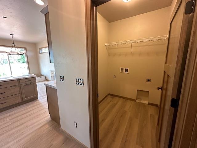 laundry area featuring washer hookup, hookup for an electric dryer, and light wood-type flooring