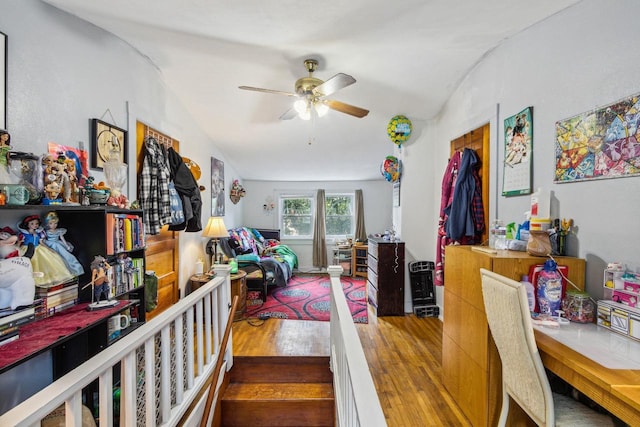 living room featuring ceiling fan, hardwood / wood-style flooring, and lofted ceiling