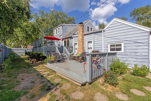 back of house featuring a deck