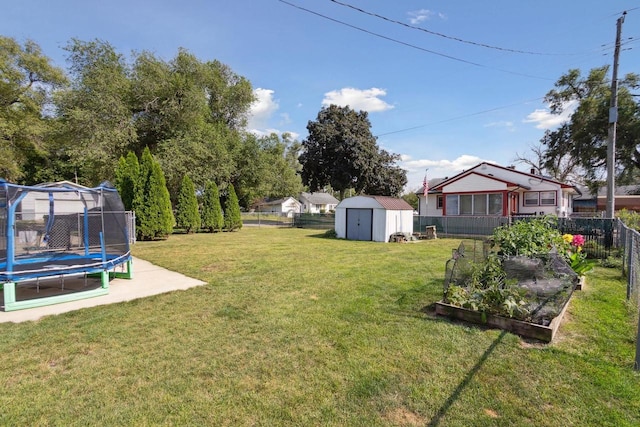 view of yard featuring a storage shed and a trampoline