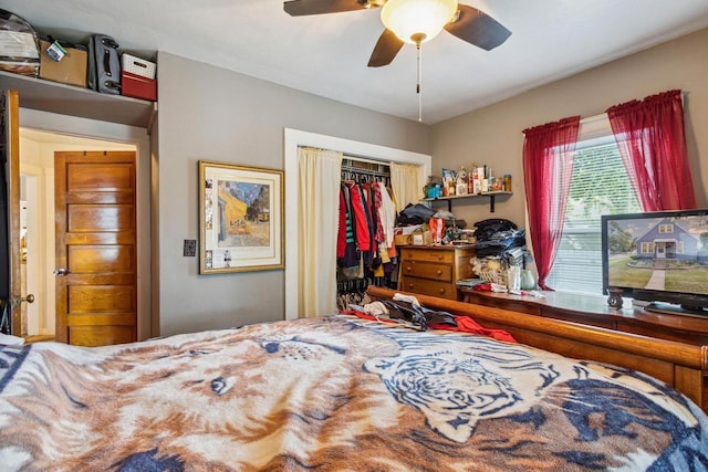 bedroom with ceiling fan and a closet