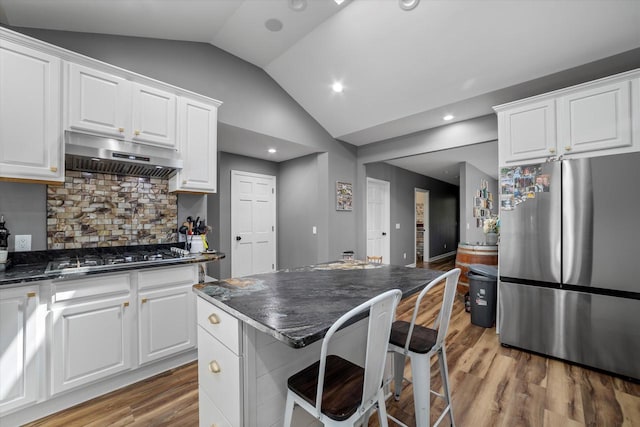 kitchen featuring hardwood / wood-style floors, stainless steel appliances, and white cabinetry