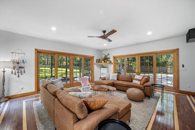 living room featuring hardwood / wood-style floors and ceiling fan