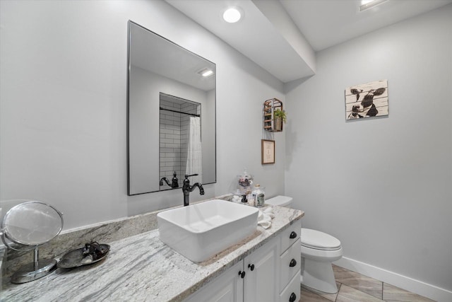 bathroom featuring toilet, tile patterned floors, and vanity