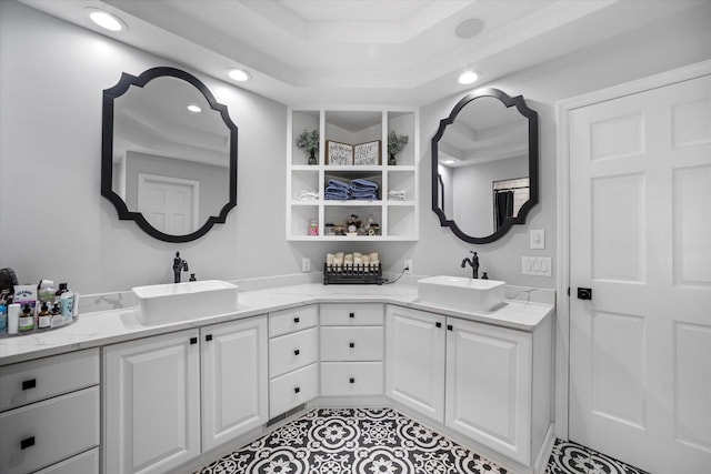 bathroom with dual vanity, tile patterned floors, and a raised ceiling