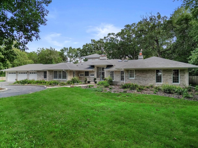 view of front of home featuring a garage and a front lawn