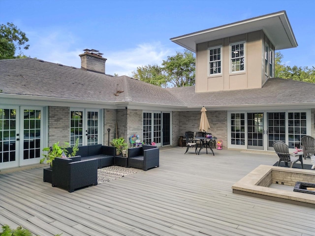 wooden terrace featuring an outdoor hangout area and french doors