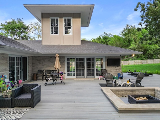 wooden deck with an outdoor living space with a fire pit