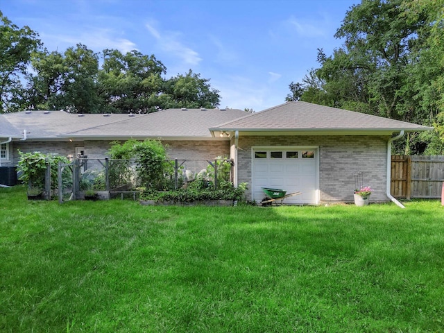 exterior space with a garage and a lawn