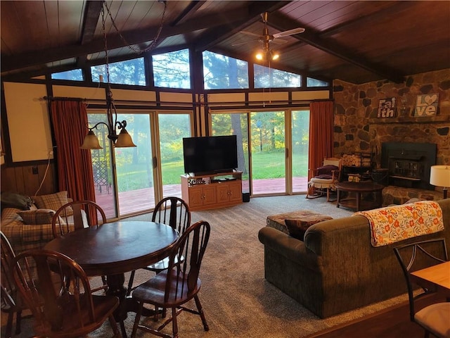 carpeted living room with wood ceiling, a healthy amount of sunlight, and beamed ceiling