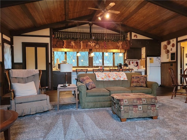 living area featuring lofted ceiling, wooden ceiling, a ceiling fan, and a wainscoted wall