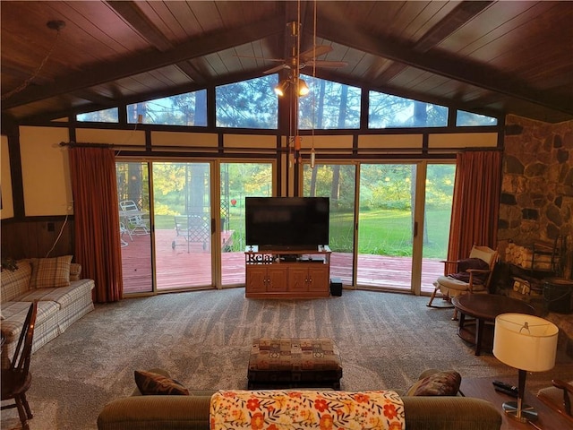 living area with carpet floors, beamed ceiling, and wood ceiling