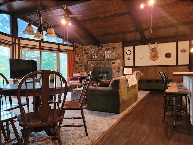 dining space featuring plenty of natural light, a fireplace, and wood ceiling