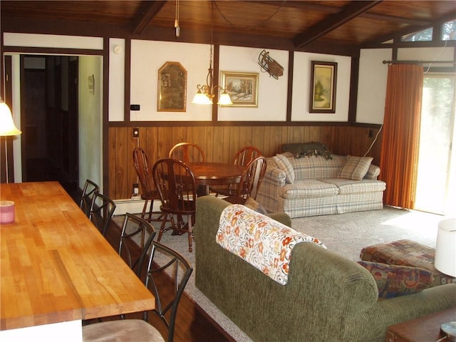 living room featuring wooden ceiling, beam ceiling, a wainscoted wall, and wood walls