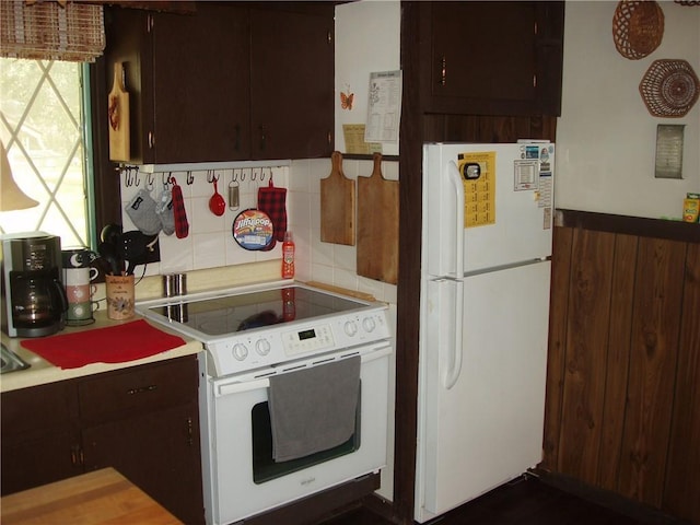 kitchen with light countertops, white appliances, backsplash, and dark brown cabinets