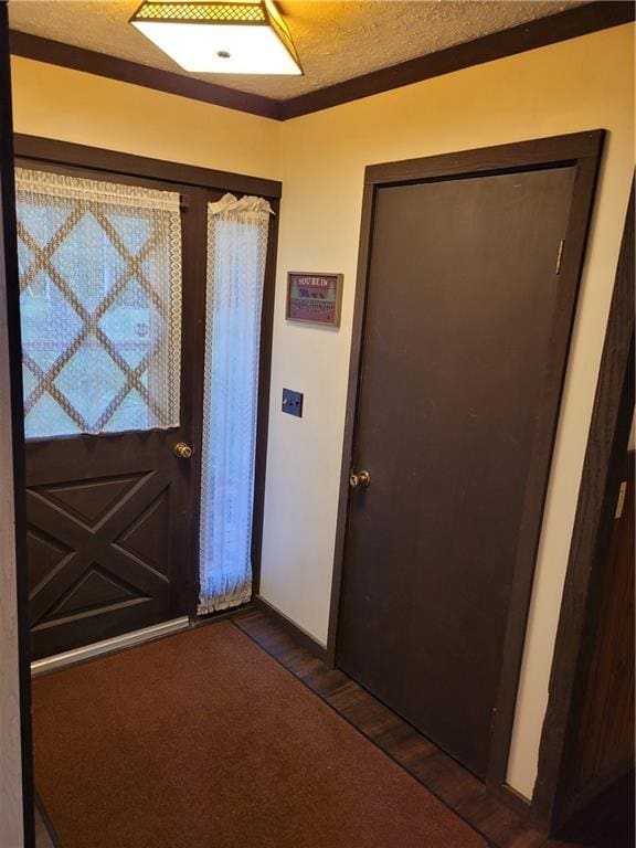 entryway featuring a textured ceiling