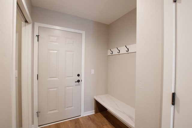 mudroom featuring baseboards and wood finished floors