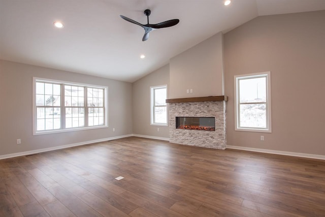 unfurnished living room featuring dark wood-style floors, ceiling fan, a fireplace, and baseboards