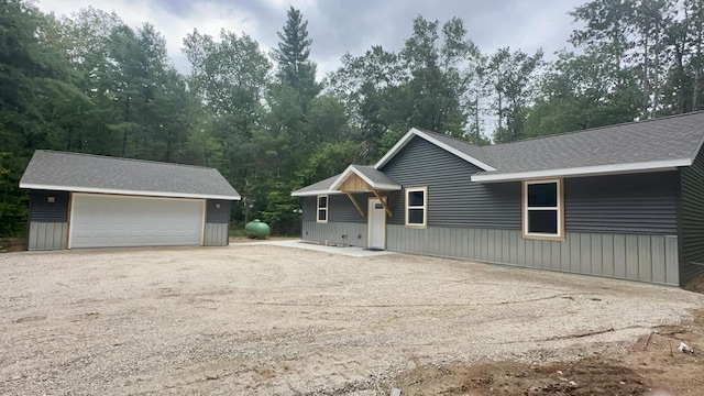 view of front of property featuring a garage and an outdoor structure